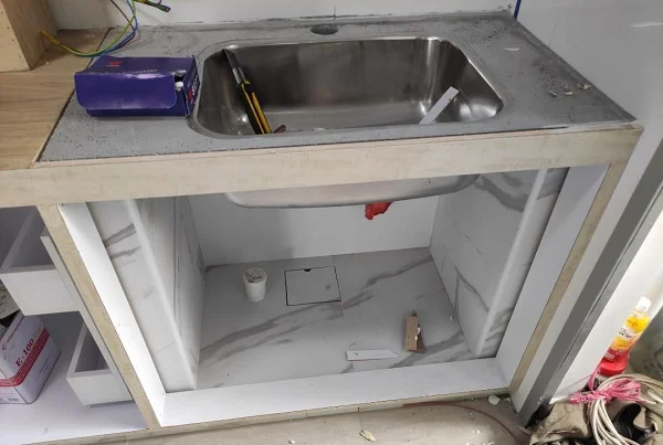 Concrete sink support after kitchen cabinet installed.